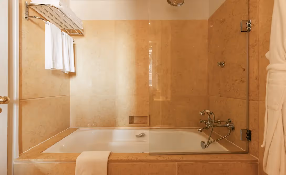 Luxurious marble bathroom with bathtub at Hotel Experimental Infante Sagres in Porto.