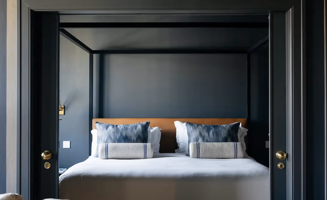 Detail of the bedding and canopy bed at Hotel Experimental Infante Sagres in Porto.