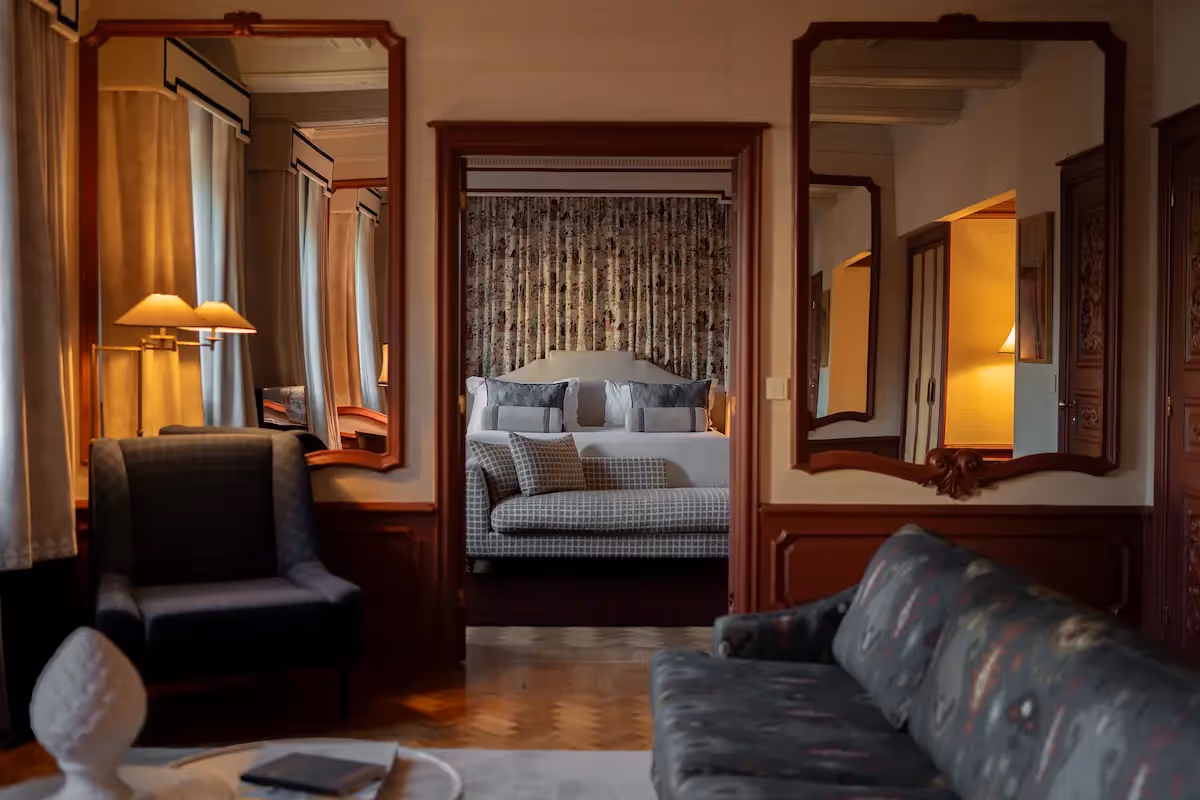 Luxury suite showing the seating area with a view of the bedroom in the background at the Hotel Experimental Infante Sagres in Porto.