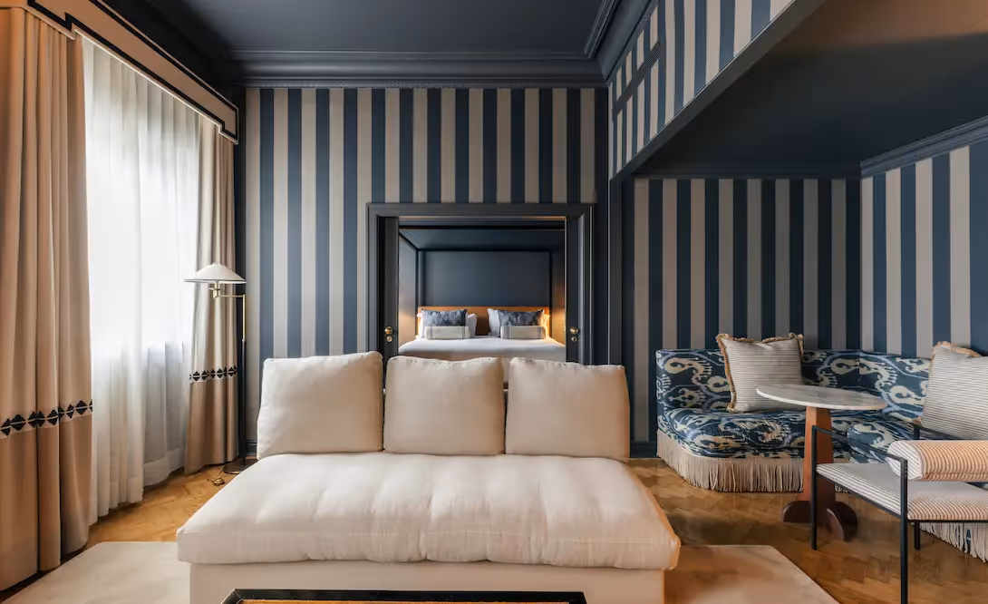 Elegant living room with striped wallpaper at Hotel Experimental Infante Sagres in Porto.