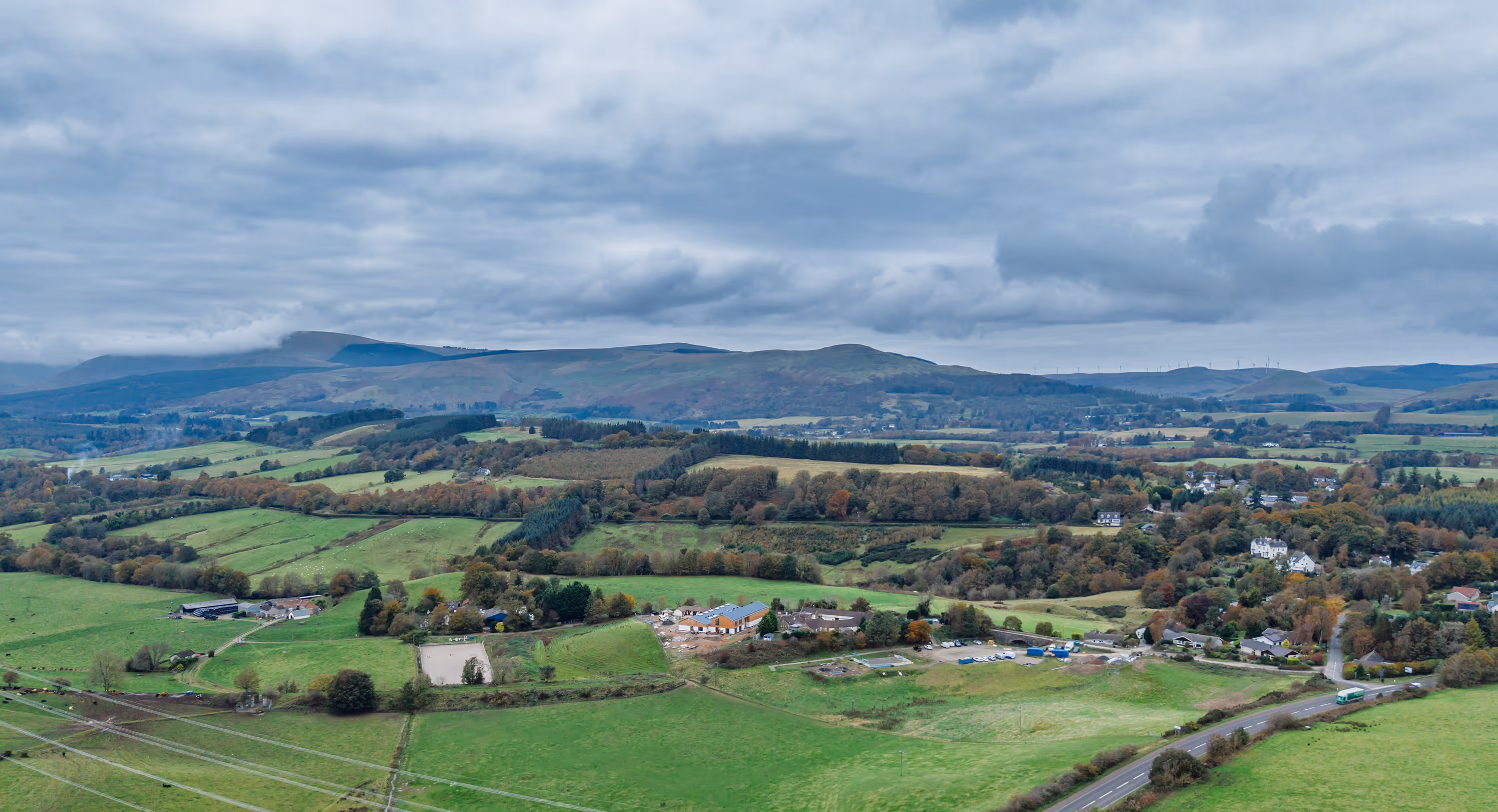 Aerial view of Seamab school surrounded by countryside with the Ochill hills in the background.