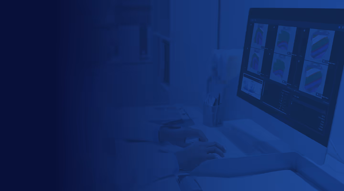 Person working on computer with medical imaging screens in blue-tinted office