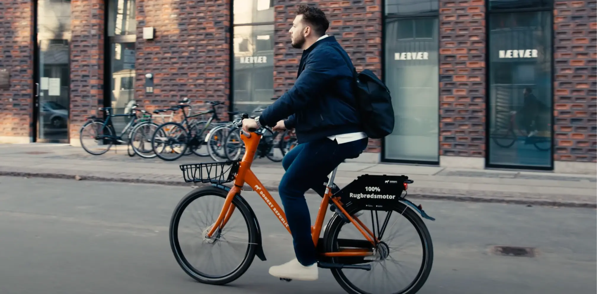 A man riding a bike down a street.