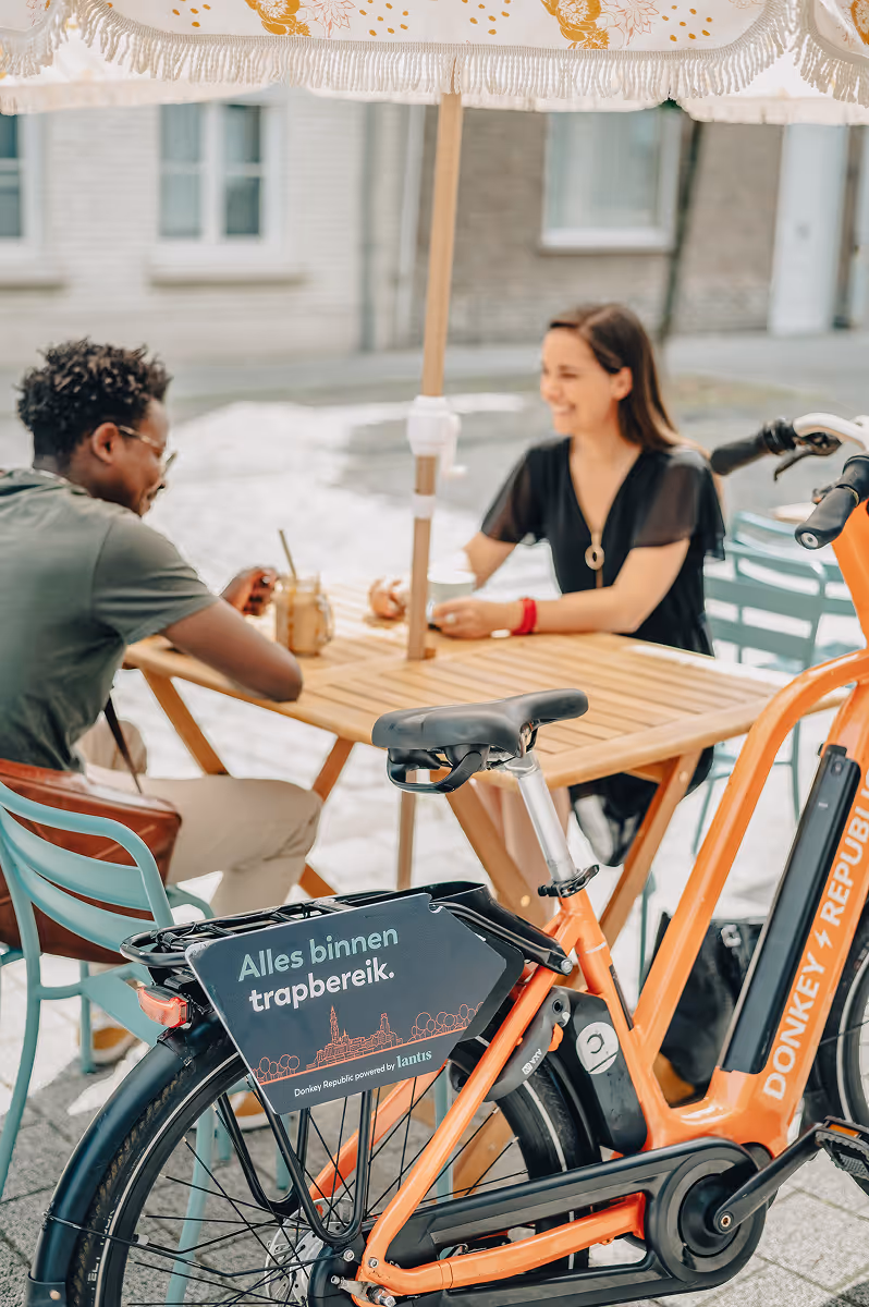 Couple in a cafe and a bike