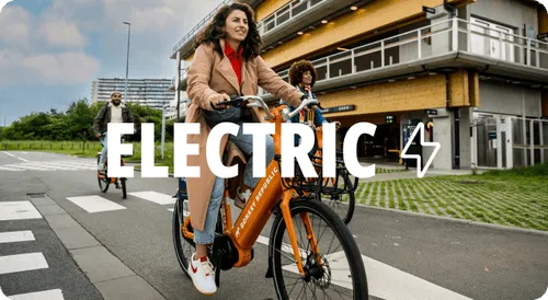 A woman riding a bike down a street.