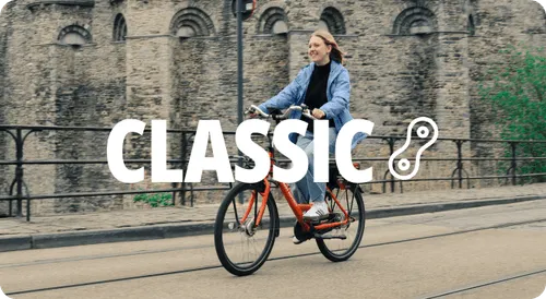 A woman riding a bike down a street.