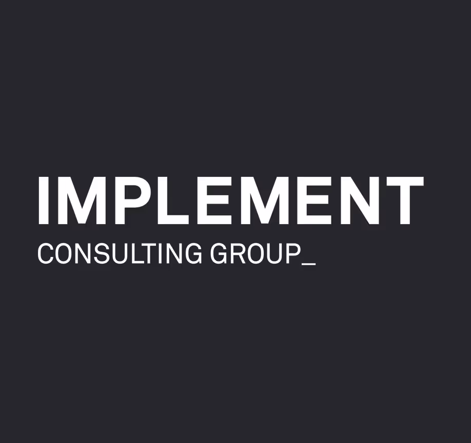 A black and white photo with the words implement consulting group.