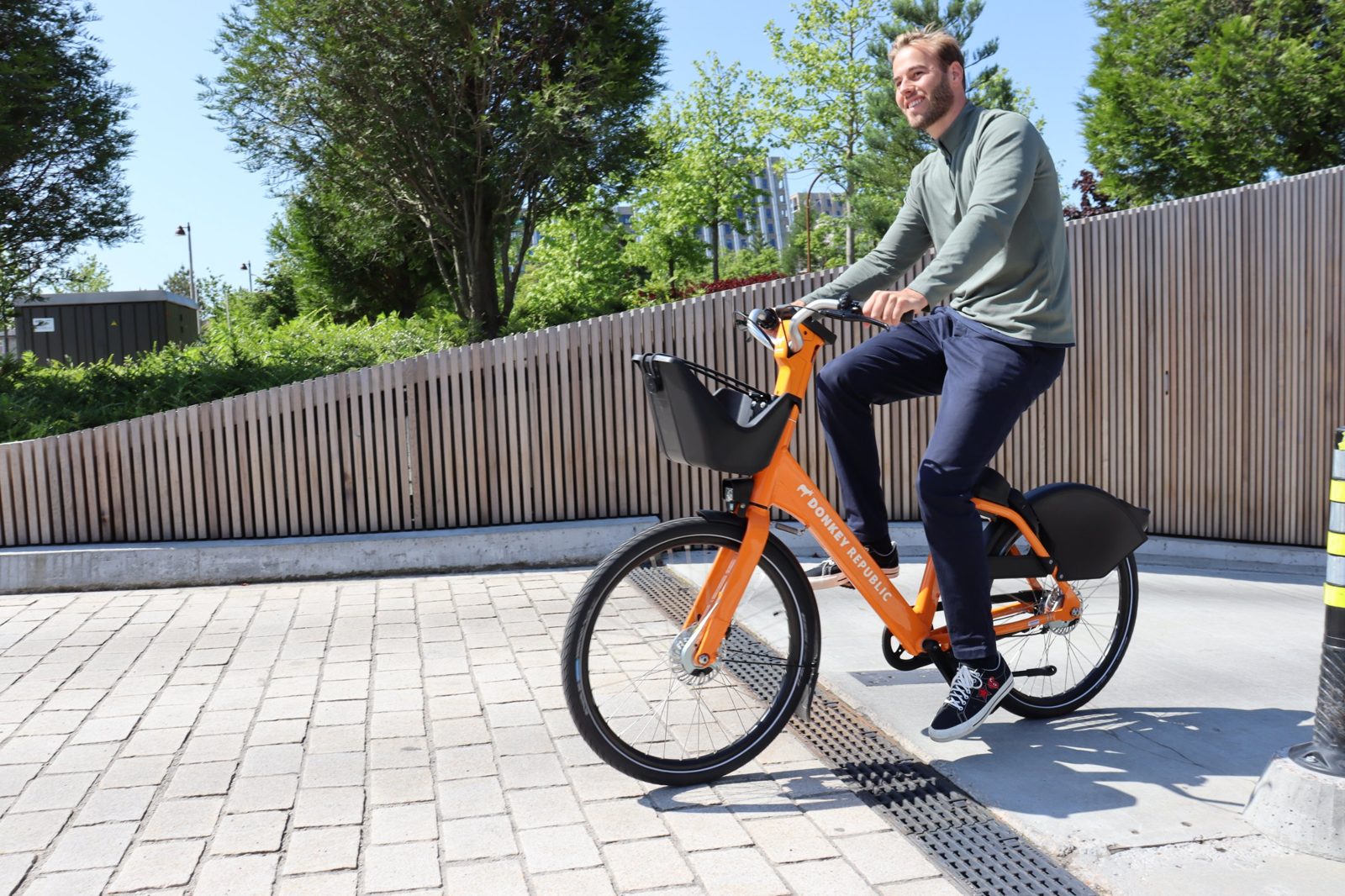 Rider on an orange Donkey Republic bike