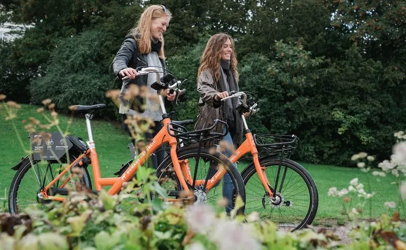 girls happy bike park green Donkey Republic bike-share