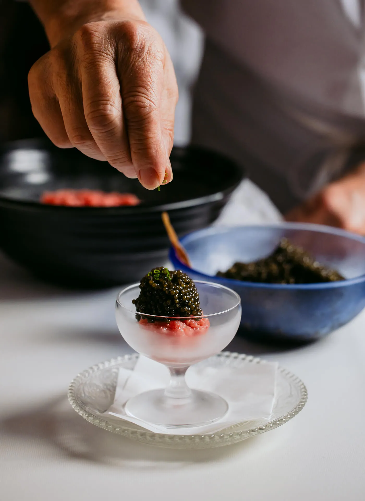 Step 1/3 of a Chef carefully preparing Masa Toro Tartare Caviar 