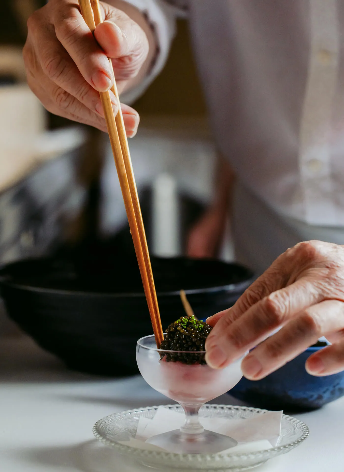 Step 2/3 of a Chef carefully preparing Masa Toro Tartare Caviar 