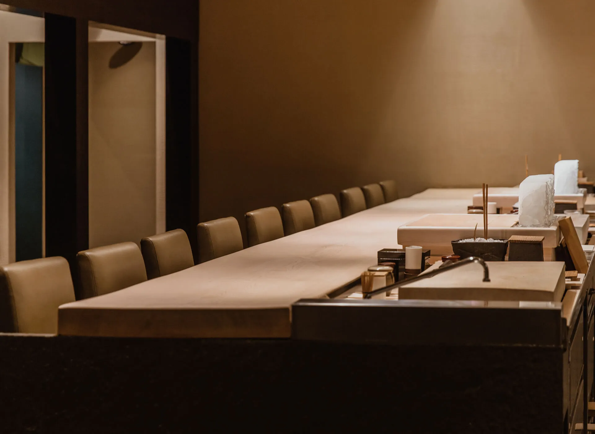 A cinematic image of the Omakase counter at Masa