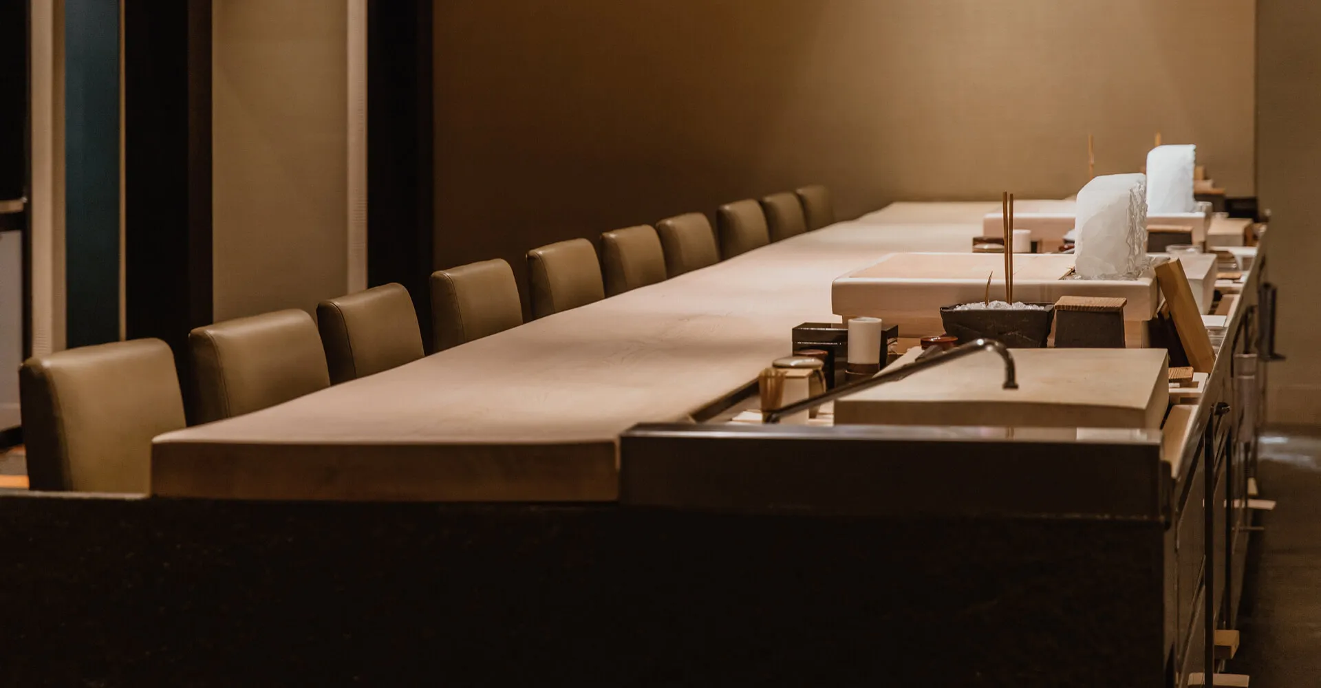 A cinematic image of the Omakase counter at Masa