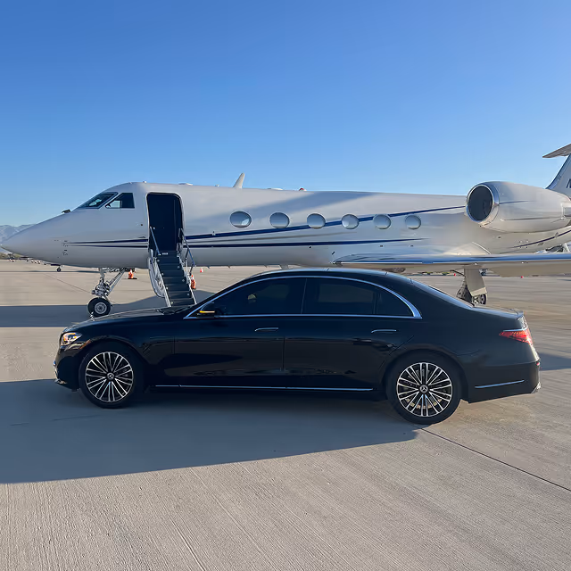Dunes Air Transport service luxury car in front of a private jet