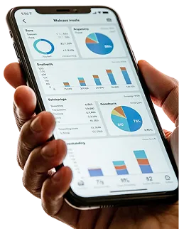 Hand holding a phone filled with charts