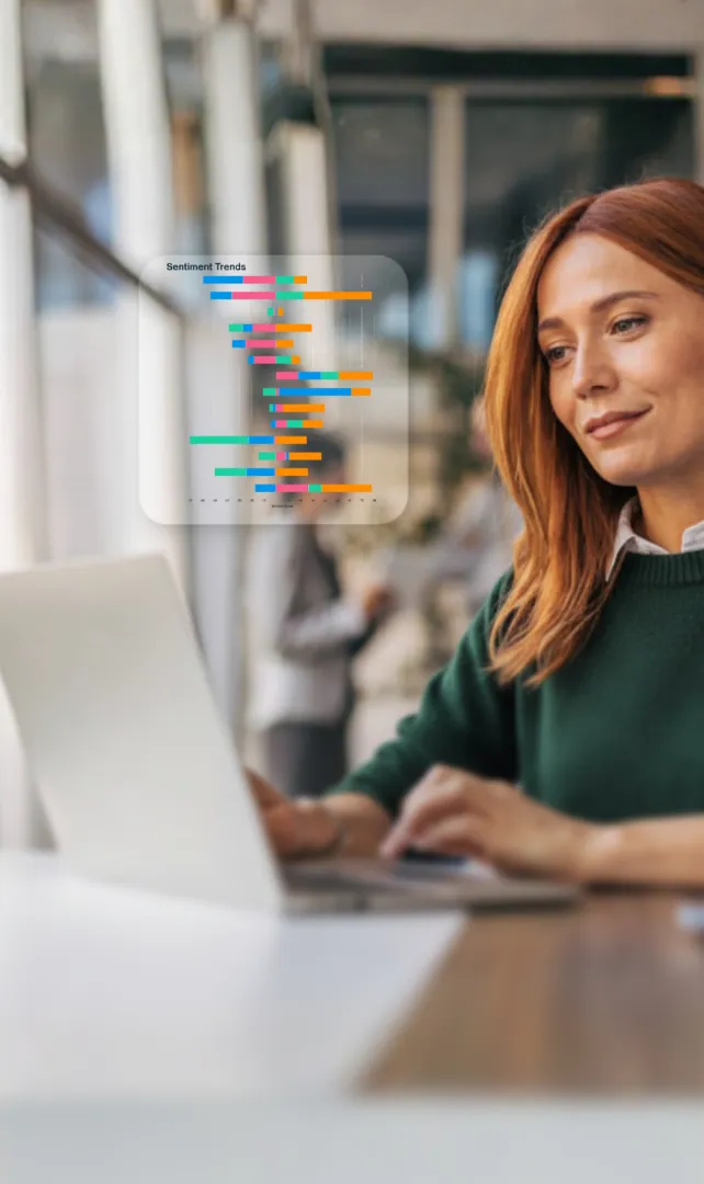 Woman working on a laptop with a sentiment analysis chart overlay