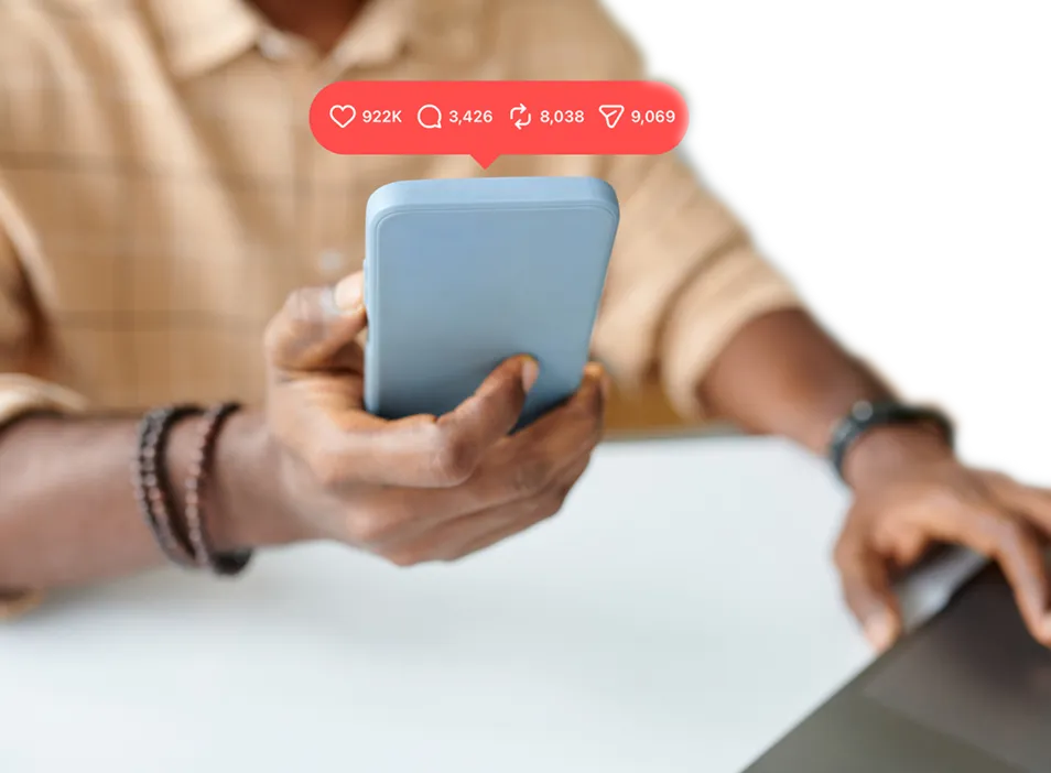 Person holding a smartphone with social media engagement icons above it