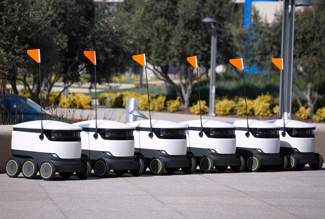 Image of self driving robots lined up and ready to deliver takeaway