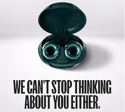 Wireless earbuds in an open charging case above the text 'WE CAN'T STOP THINKING ABOUT YOU EITHER.'