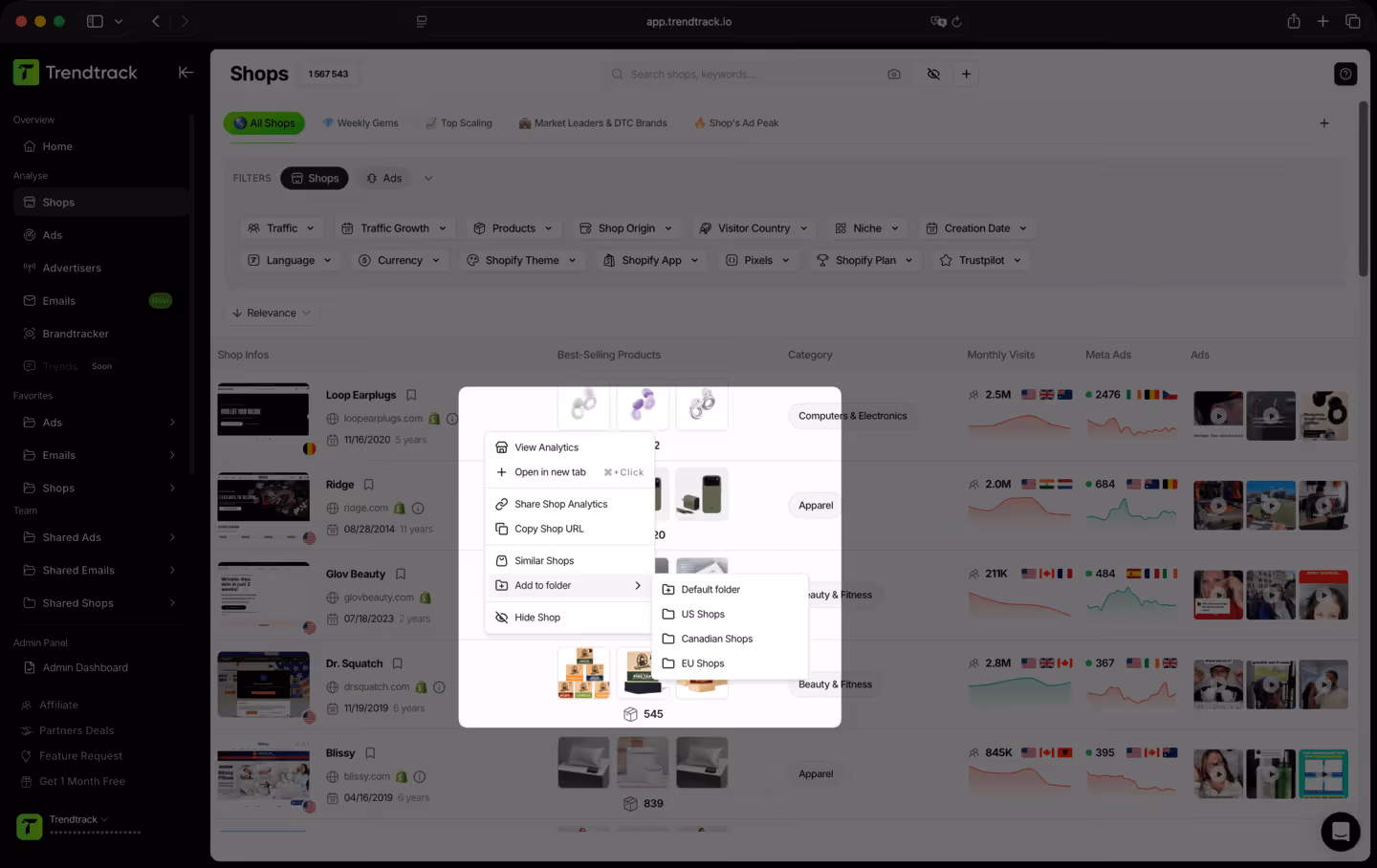 Trendtrack app interface showing a list of online shops with options to view analytics, add shops to folders like US Shops or EU Shops, and shop details including category and monthly visits.