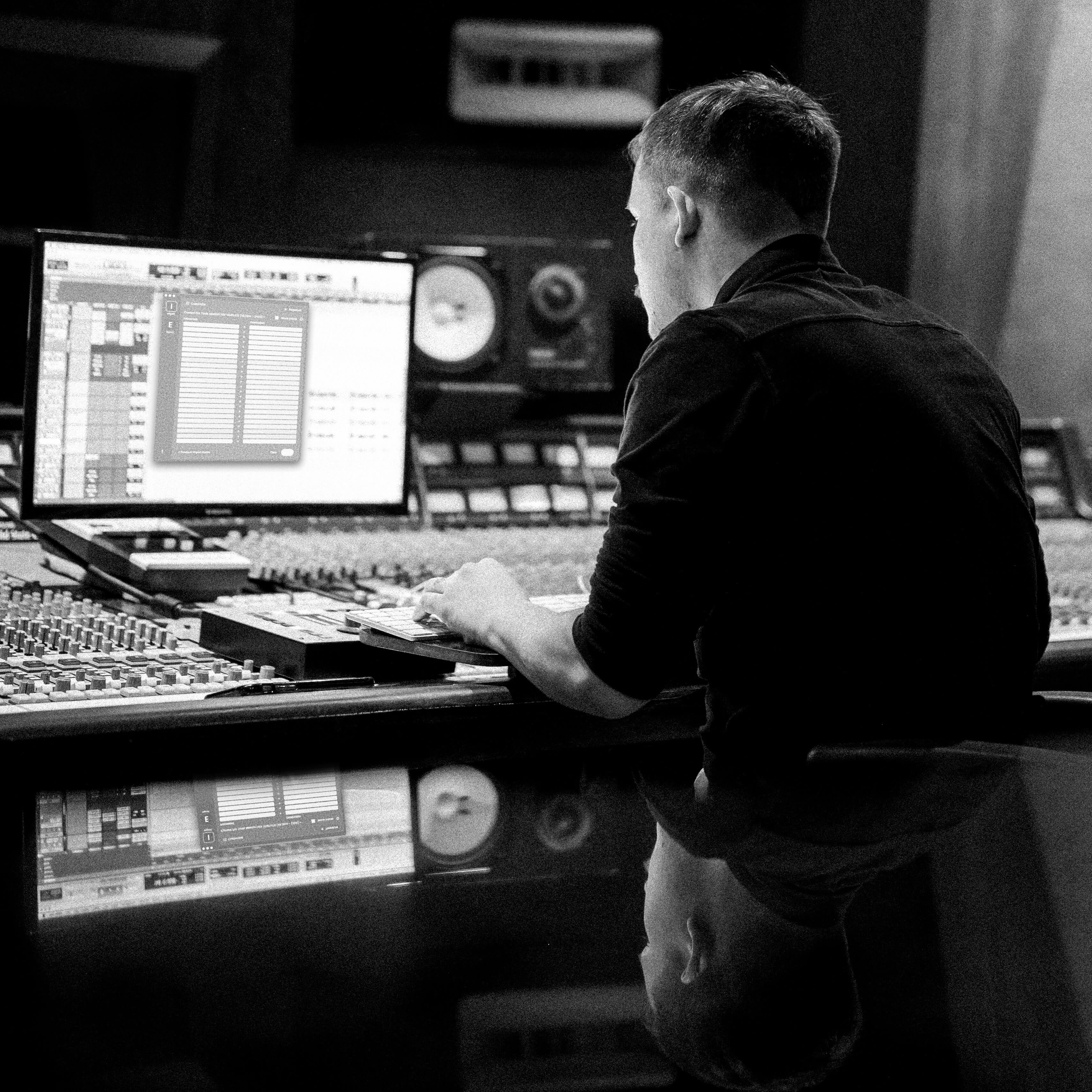 Sound engineer at mixing console using Forte AI audio automation — integration template workflow for studio professionals