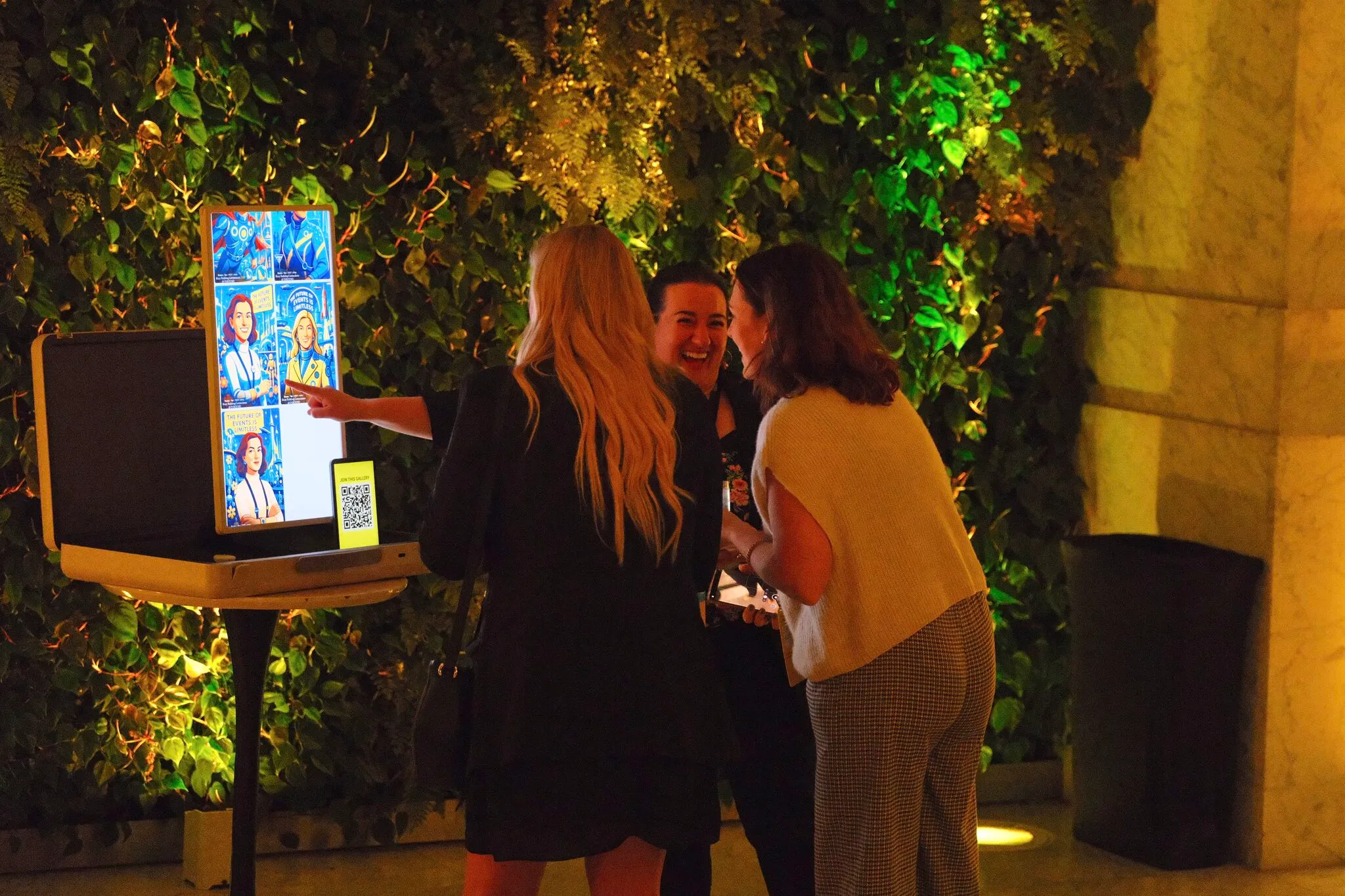 Attendees using an AI photo booth at a corporate evening event