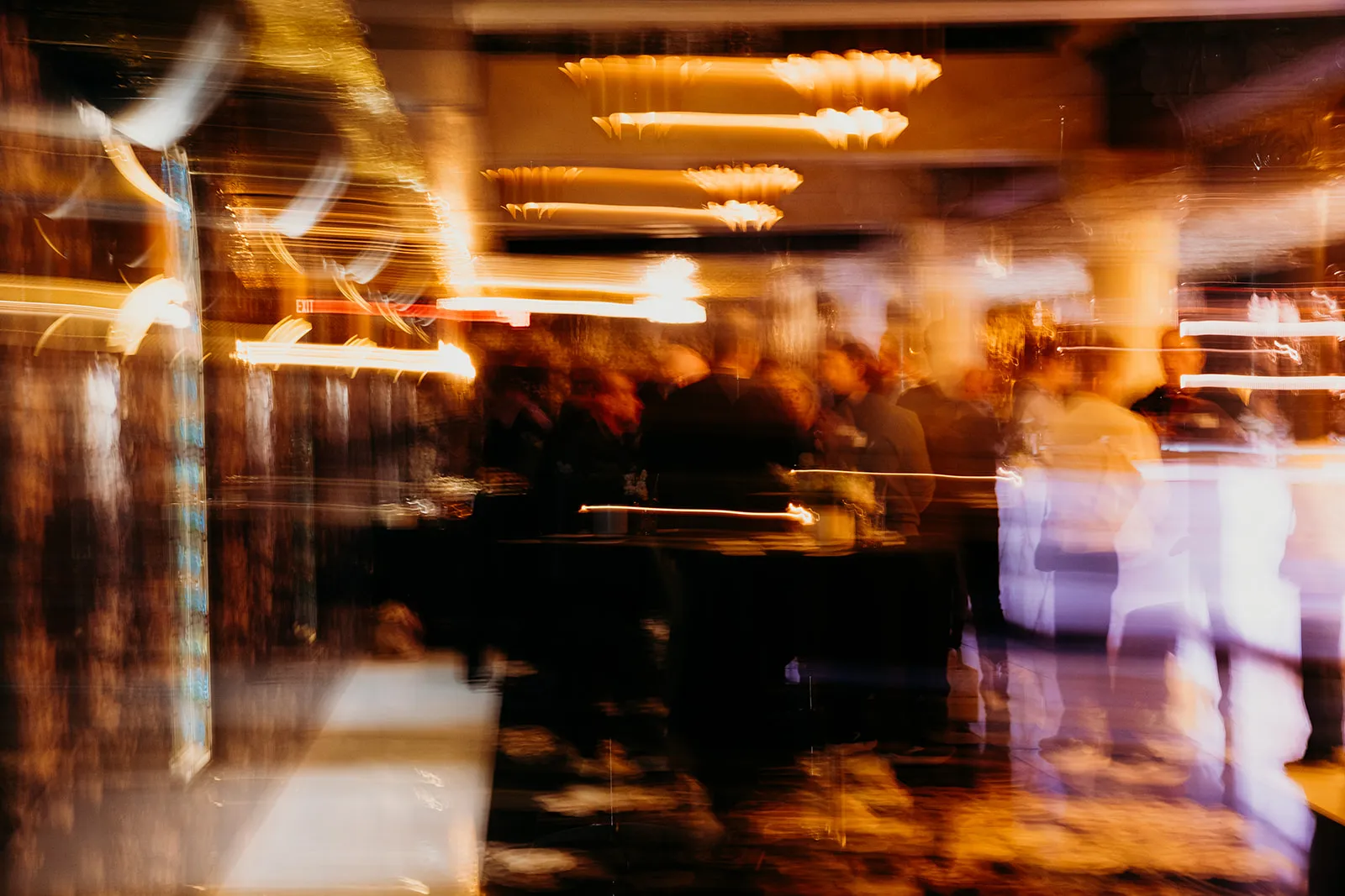 Long-exposure shot of a busy corporate evening event with ambient lighting
