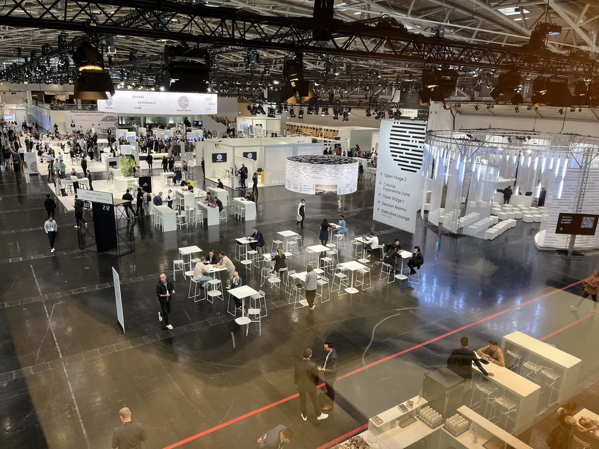 Aerial view of a large trade show floor with exhibition stands and attendees
