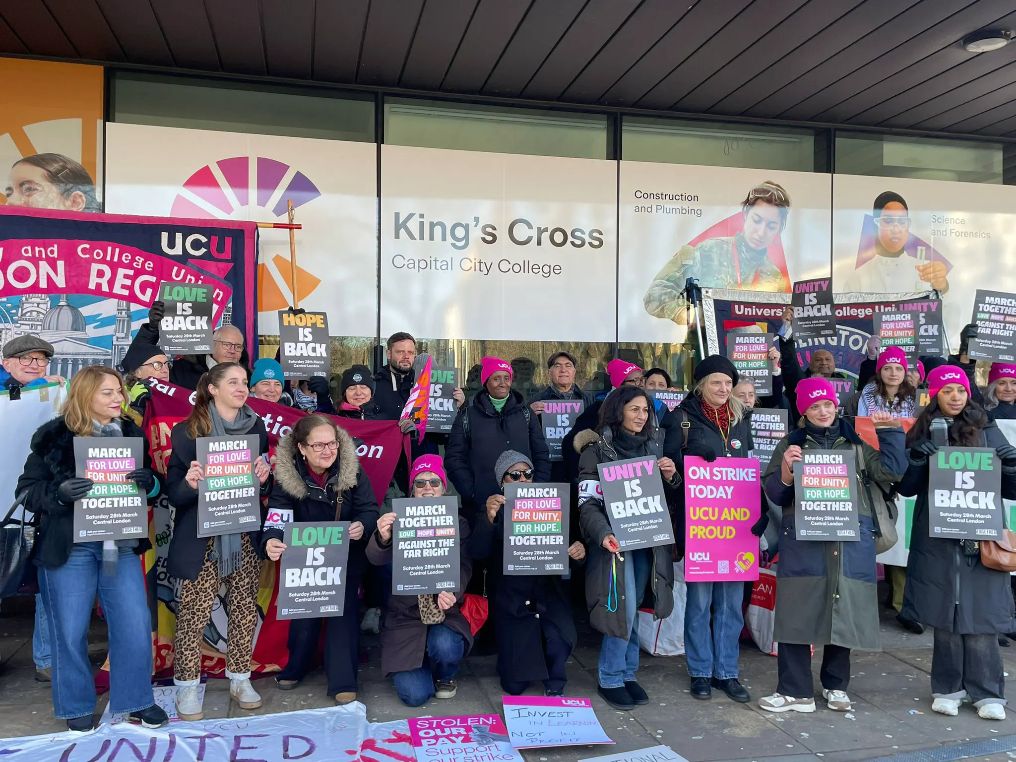 Group of protesters outside King's Cross Capital City College holding signs supporting a UCU strike.
