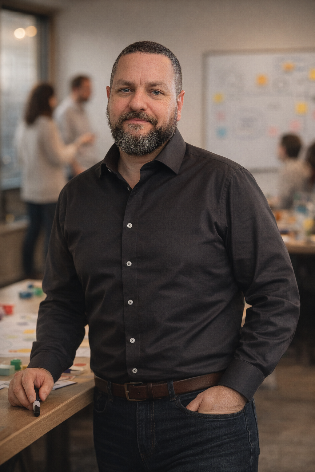 Group of five diverse adults sitting together, smiling and engaged in conversation during a casual meeting.