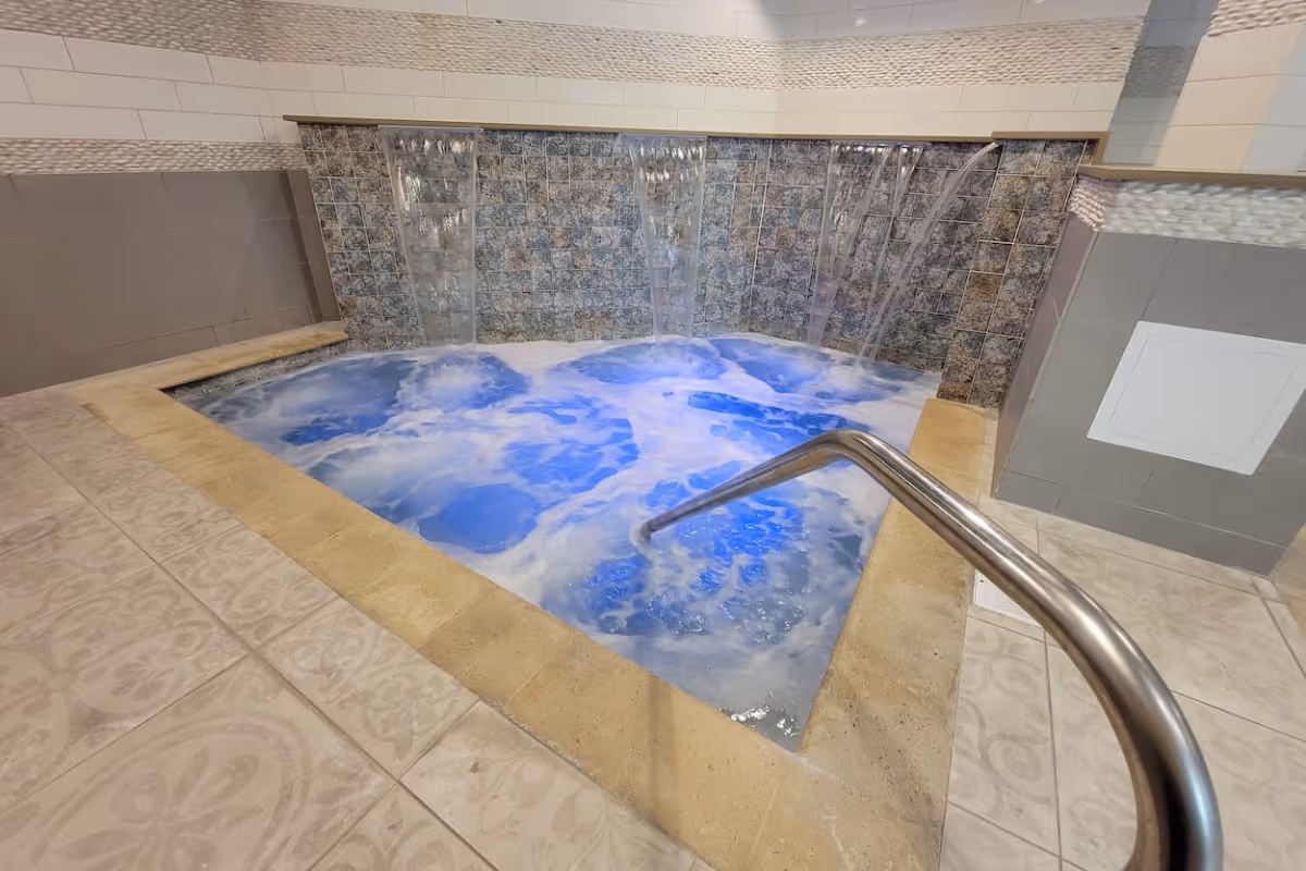 Spa center with waterfall and lounge chairs (at Novus)