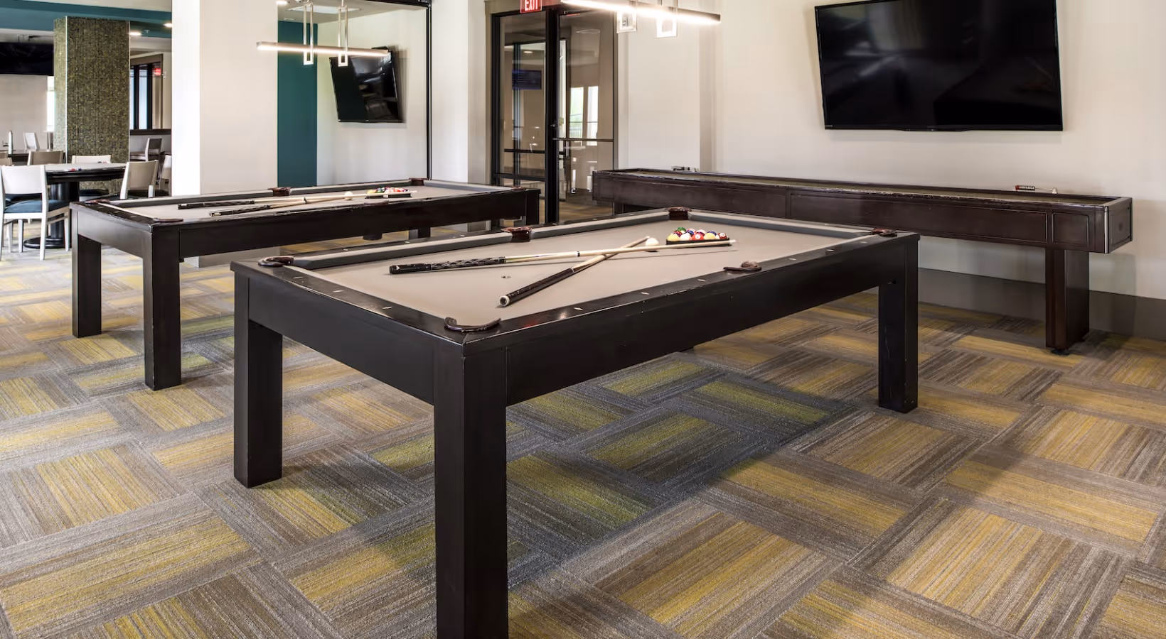 Game room lounge with billiards and shuffleboard
