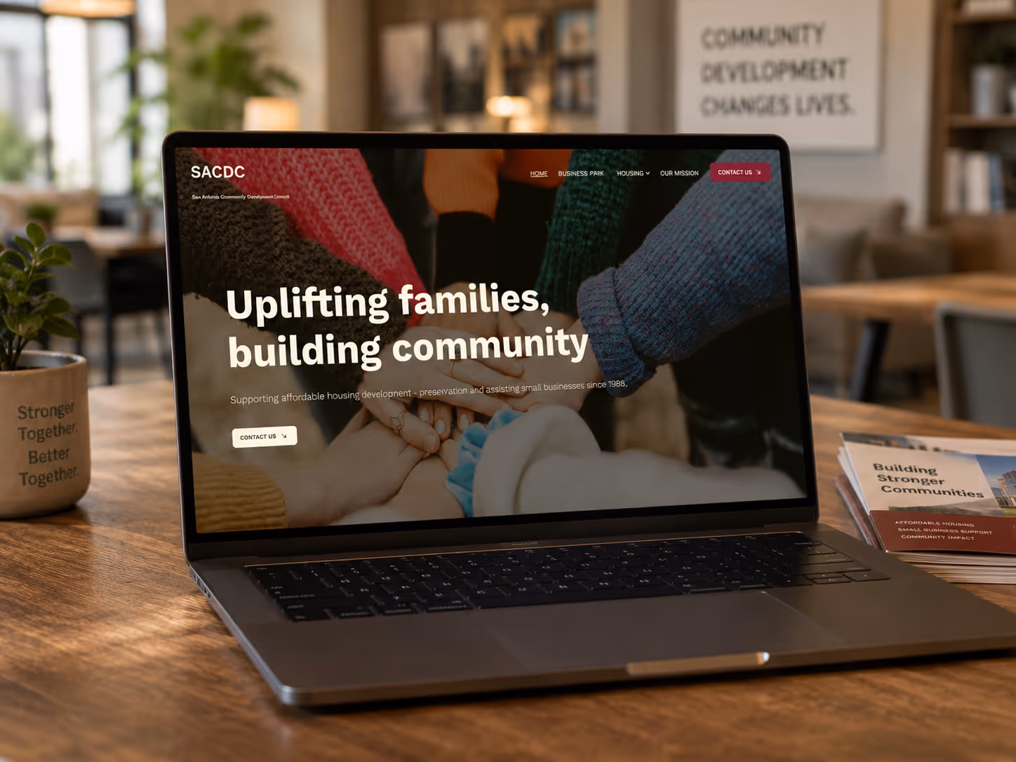 Homepage website design of San Antonio Community Development on desk