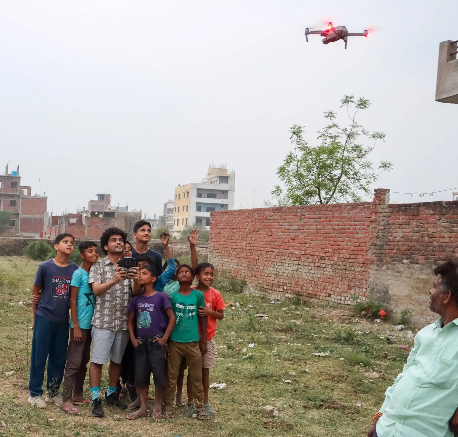 Children watching a drone take flight