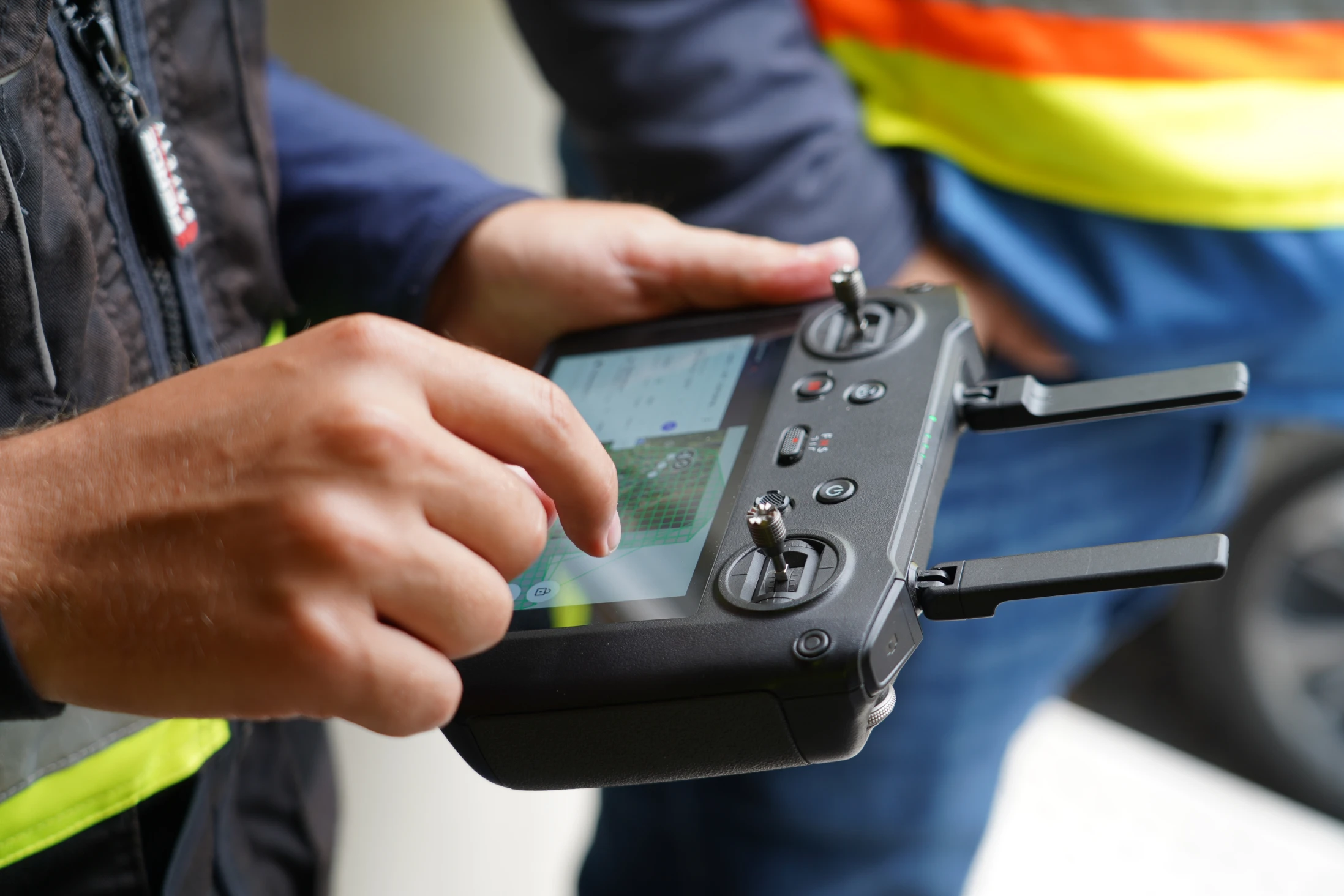 person using dji mavic 3e controller