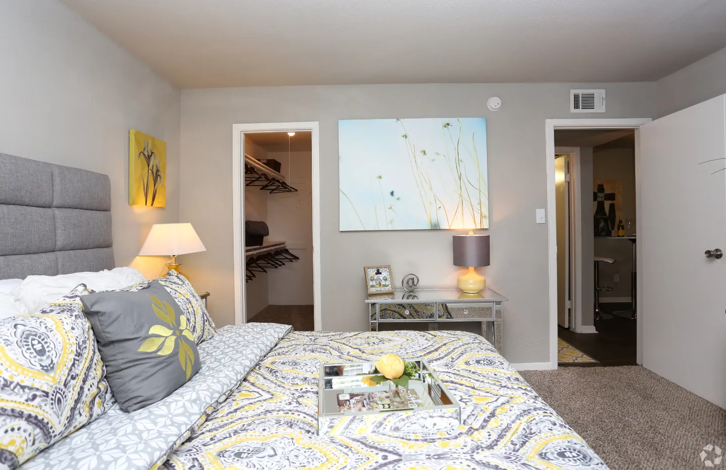 bedroom with bed and view into walk-in closer and hallway