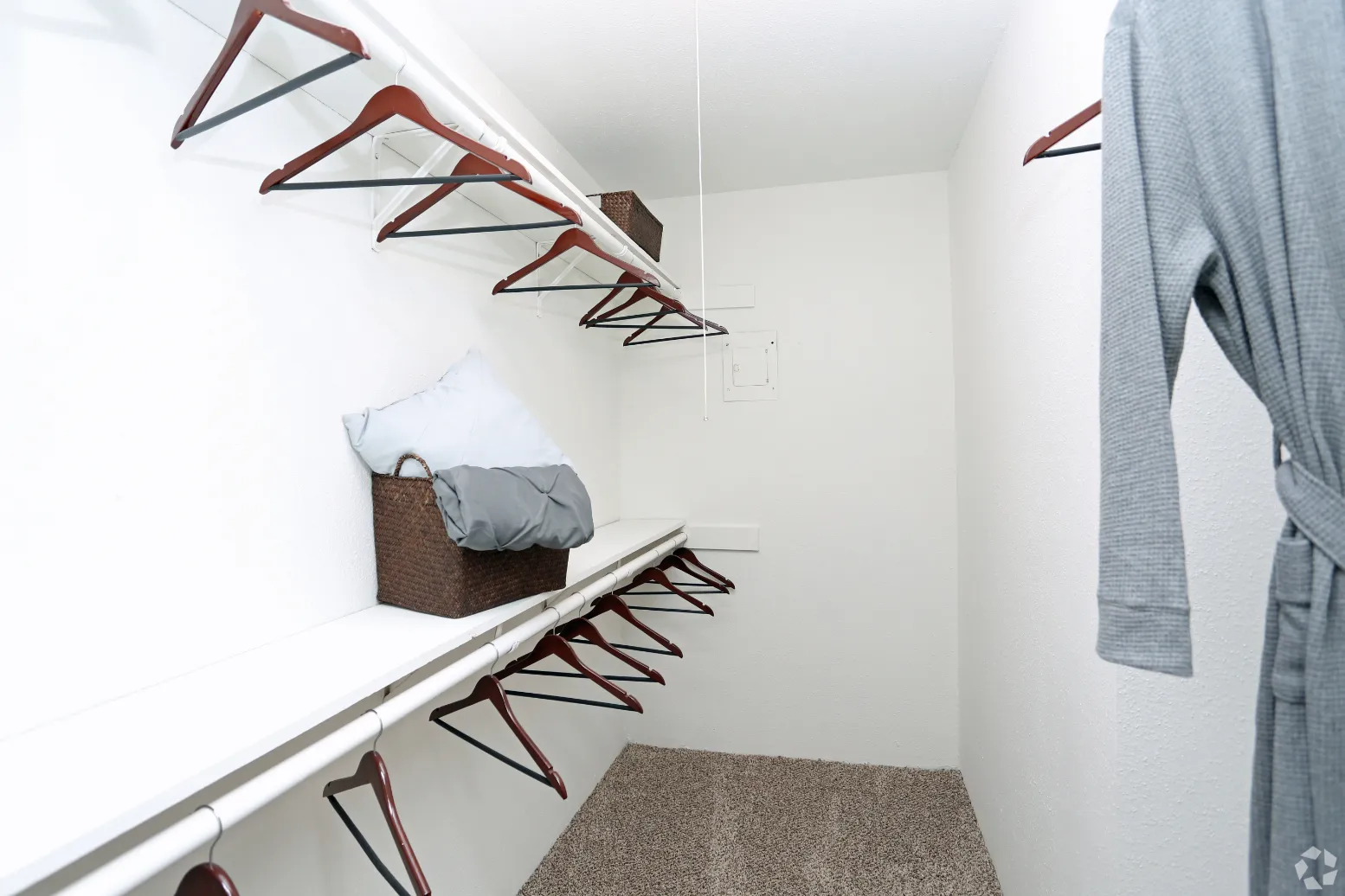 walk-in closet with hangers and bathrobe