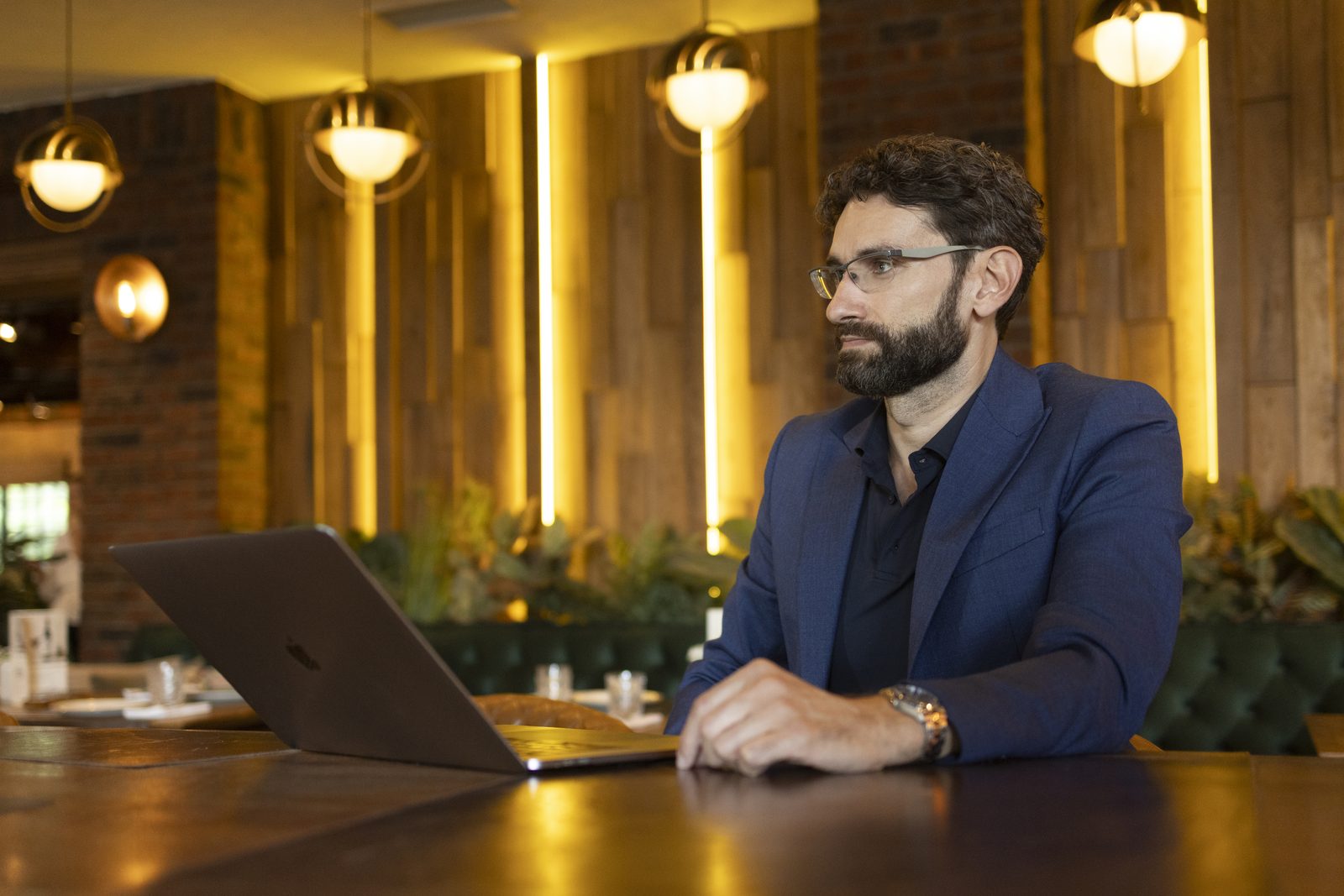 Miroslav Ćurčić at a table with a laptop, in conversation