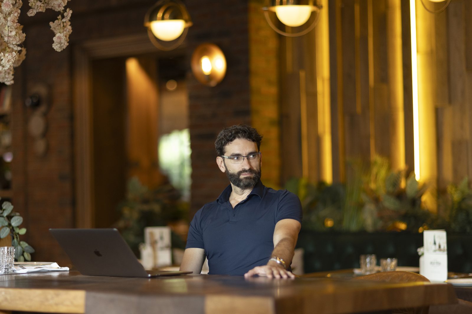 Miroslav Ćurčić seated at a table with a laptop