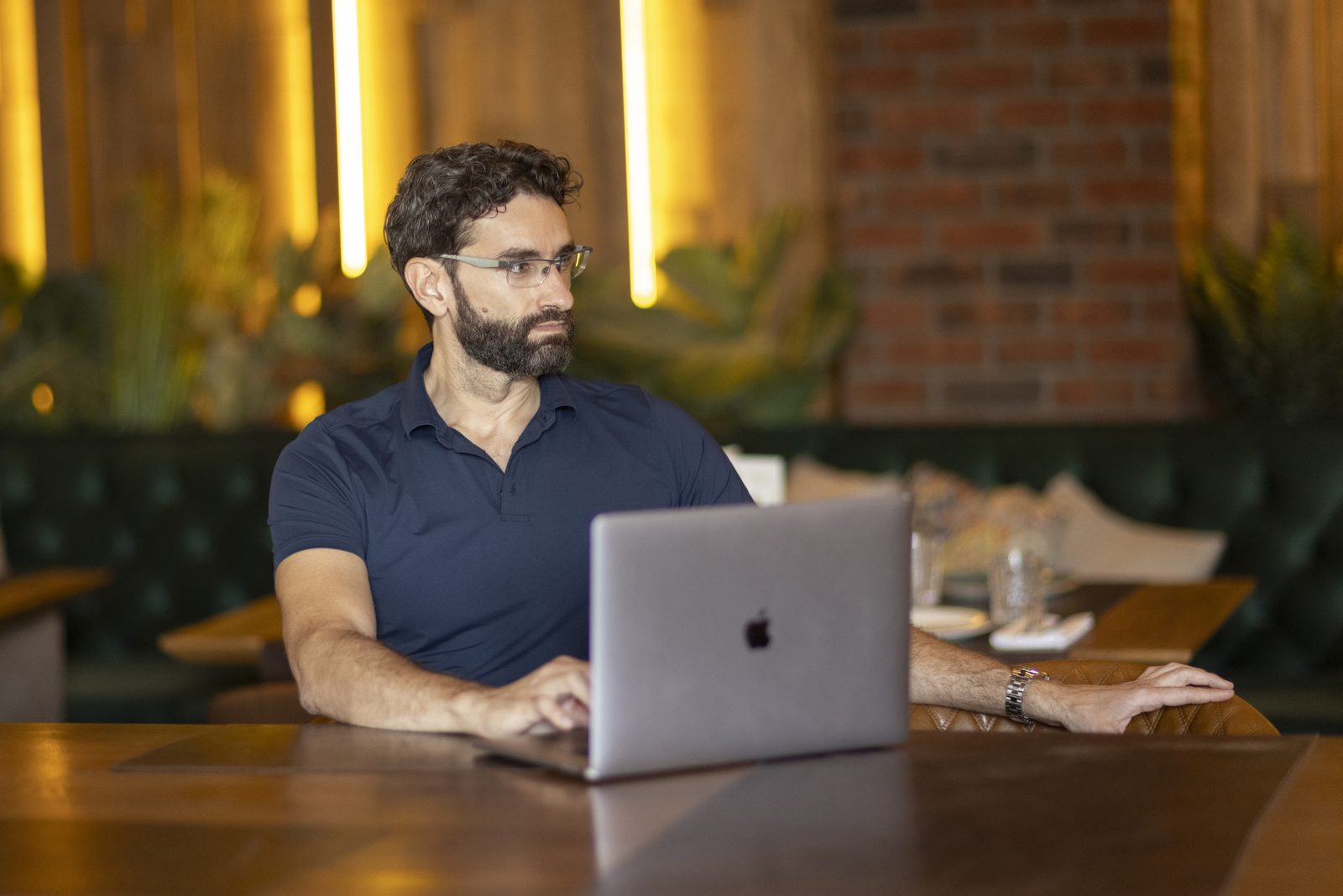 Miroslav Ćurčić at a restaurant table with a laptop
