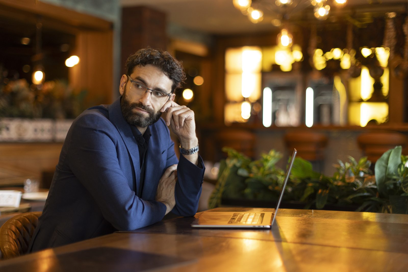 Miroslav Ćurčić thinking at a table with a laptop