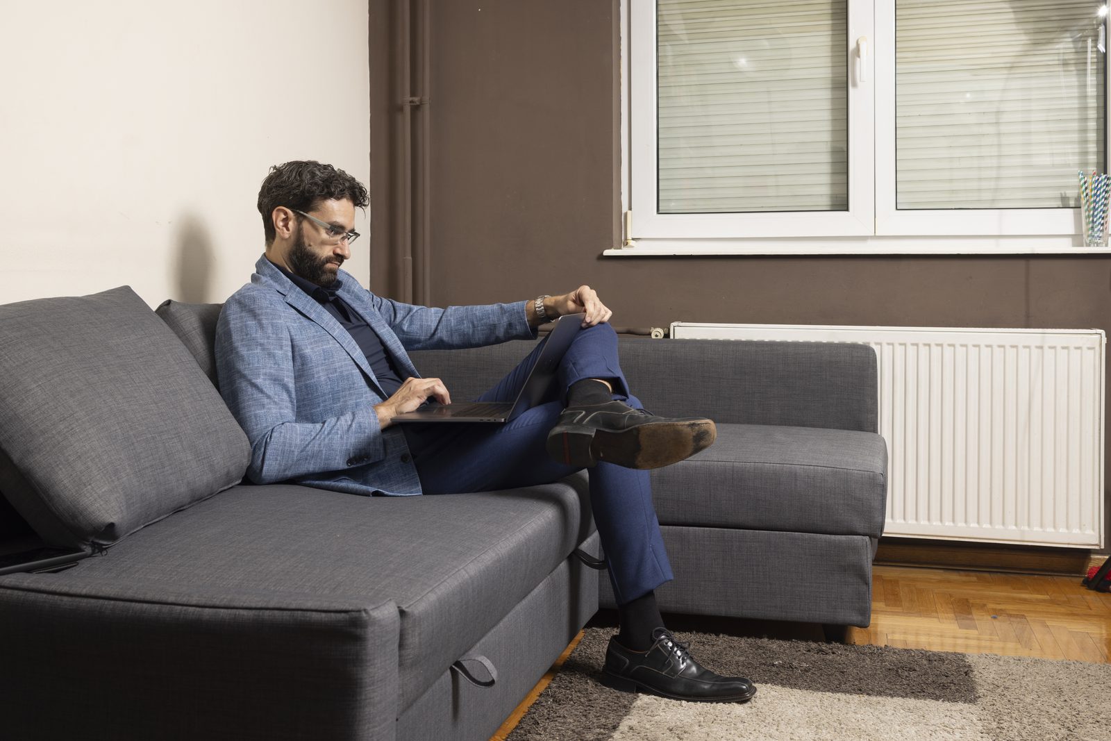 Miroslav Ćurčić sitting on a sofa in a lounge
