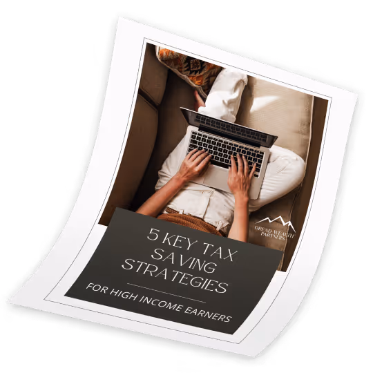 Overhead view of a person typing on a laptop while sitting cross-legged on a couch with text overlay reading '5 Key Tax Saving Strategies for High Income Earners.'