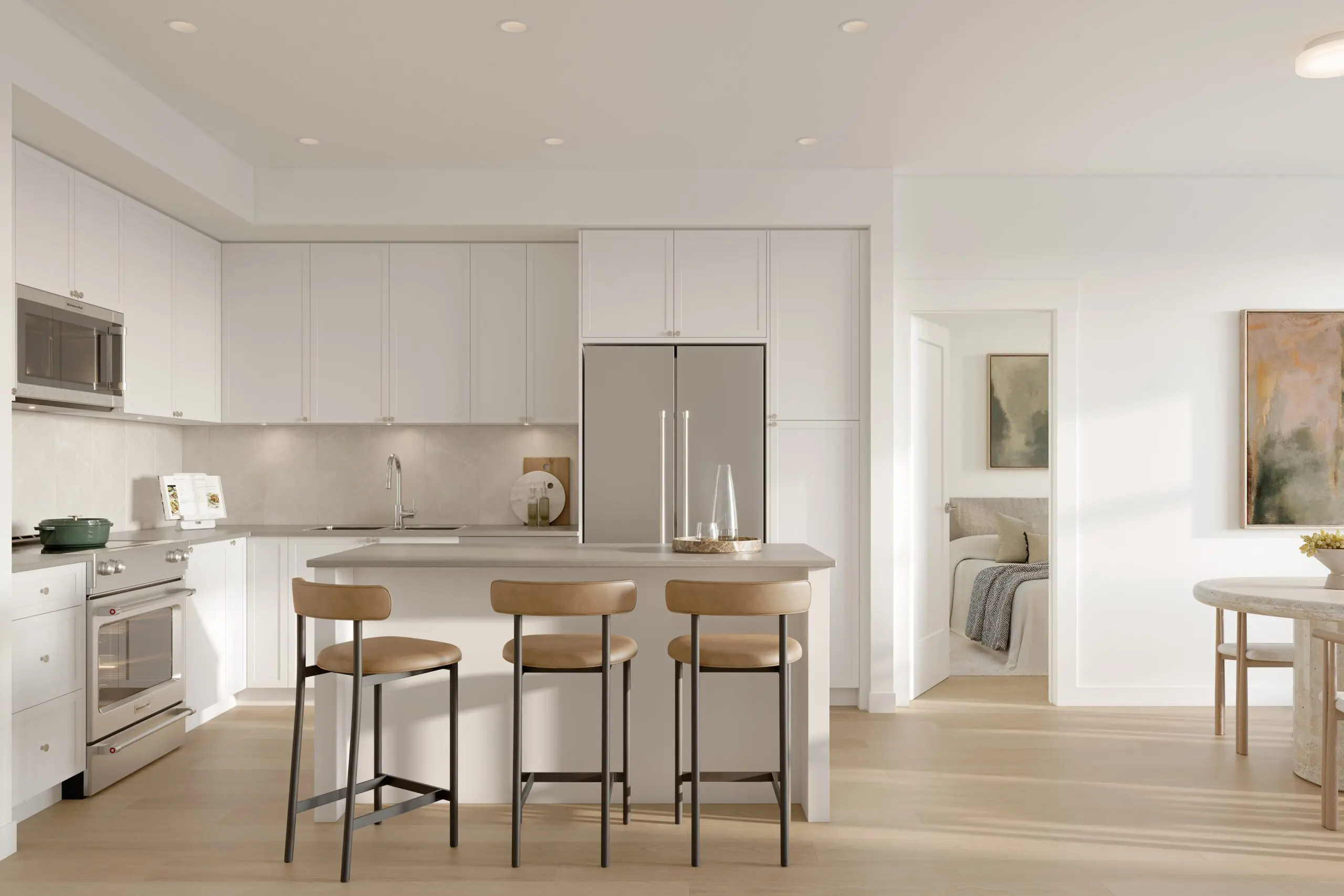 Bright Fleetwood Village 2 condo kitchen in the Classic scheme, with white shaker cabinets, an island with three stools, and stainless steel appliances