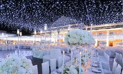 Elegant event lighting setup with string lights and decorative fixtures, creating a festive atmosphere for a celebration or party.