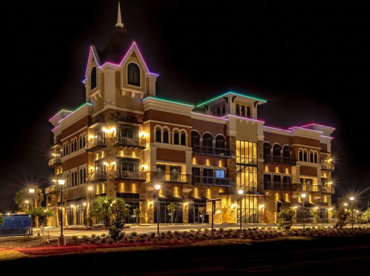 Commercial building exterior featuring custom color-changing trim lighting and architectural roofline illumination at night.