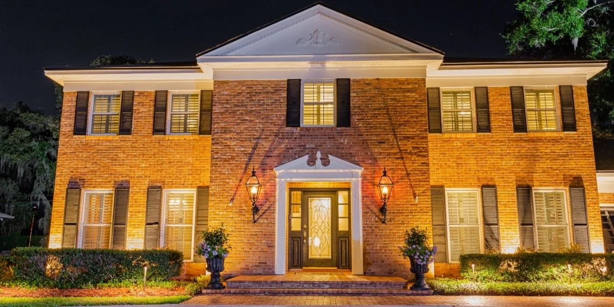 user-inserted Exterior architectural lighting highlighting a brick home's facade.