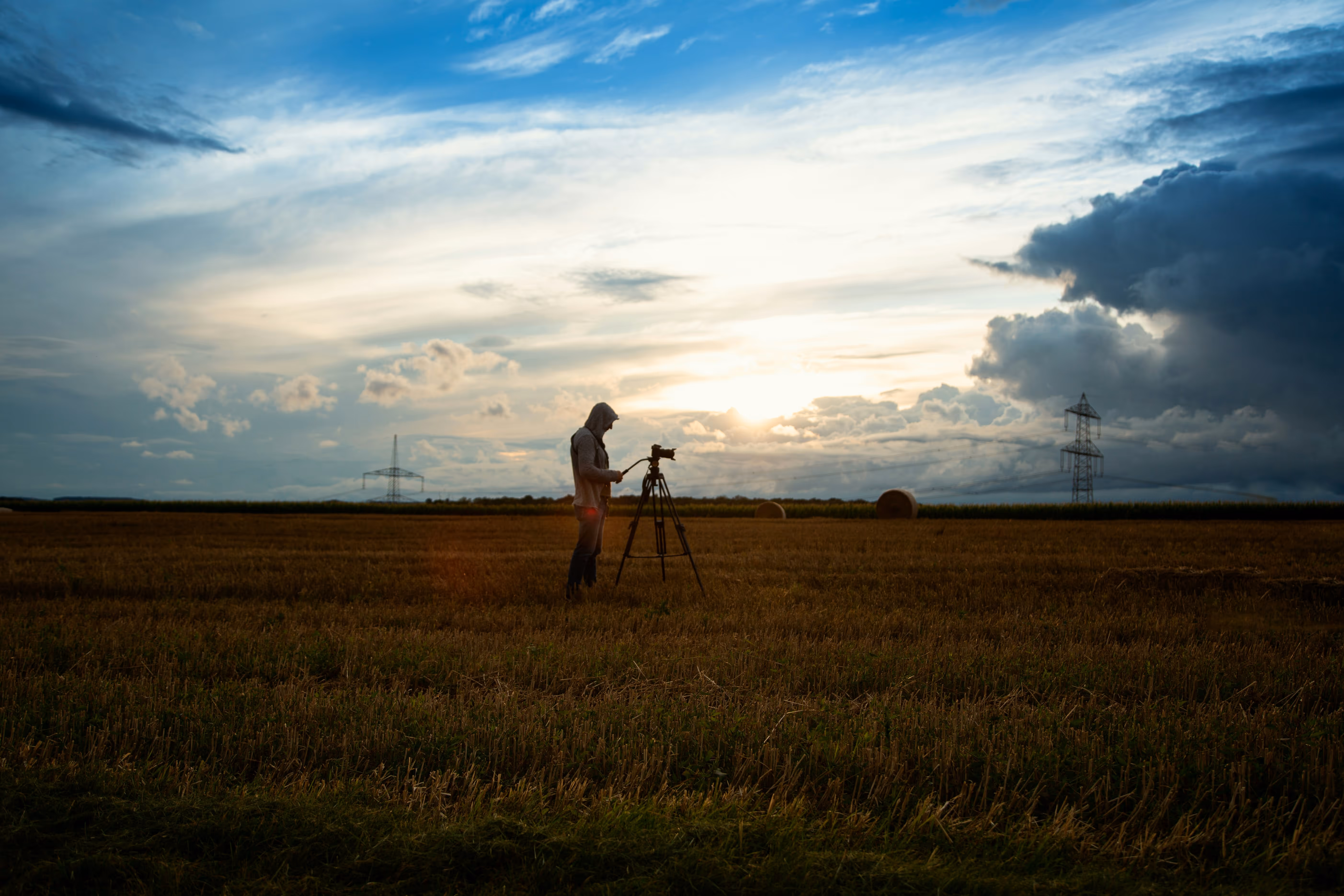 Field surveyor working at dusk with a Replicon workforce dashboard overlay showing headcount, hours worked, team productivity, and resource allocation, representing the Matidor and Replicon integration for field labor cost tracking.