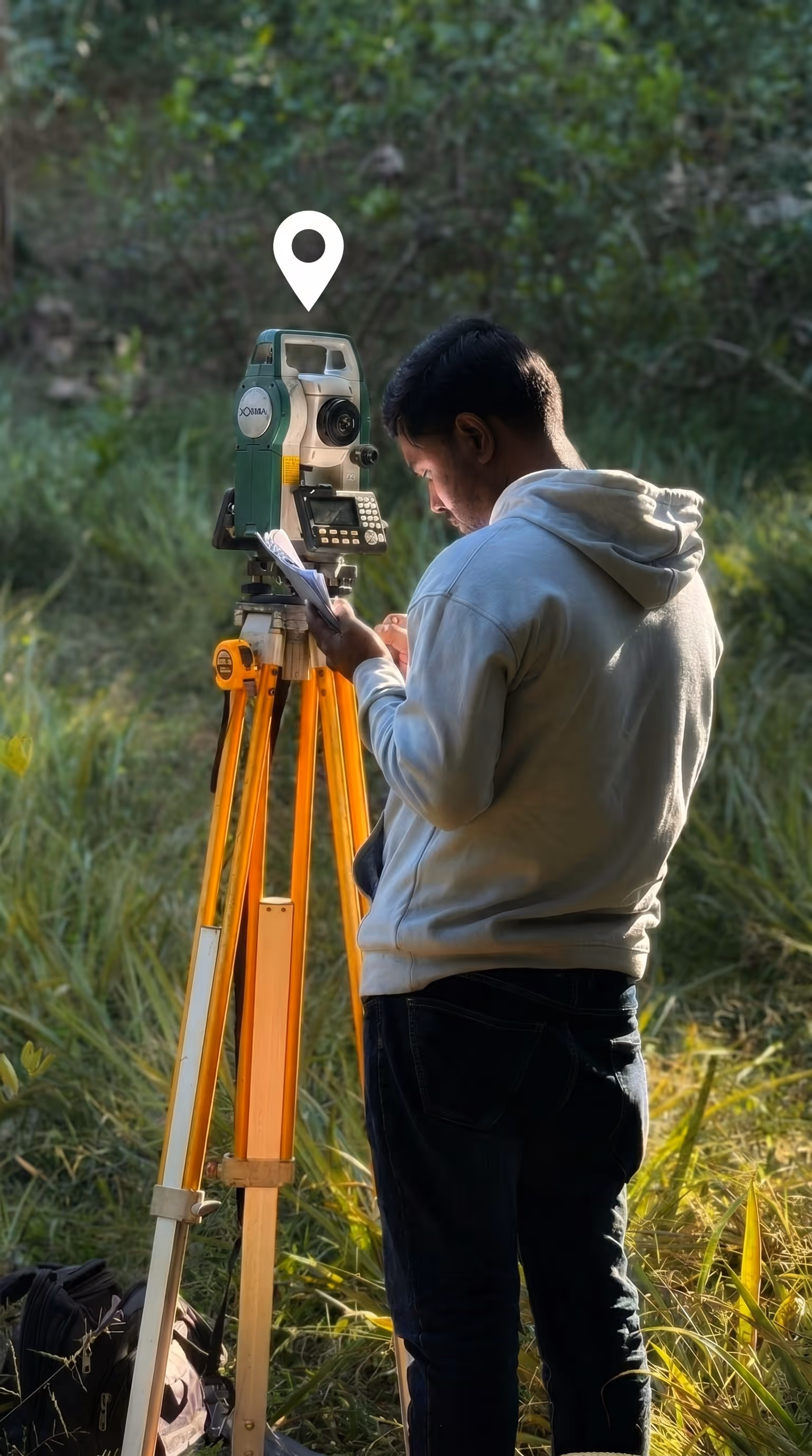 Field technician operating a total station survey instrument in a grassy field with a GPS location pin icon overhead, representing how West Country Energy Services uses Matidor's custom forms and GPS-tagged data capture to standardize field data collection across natural gas leak detection, LDAR surveys, and pipeline integrity inspections.