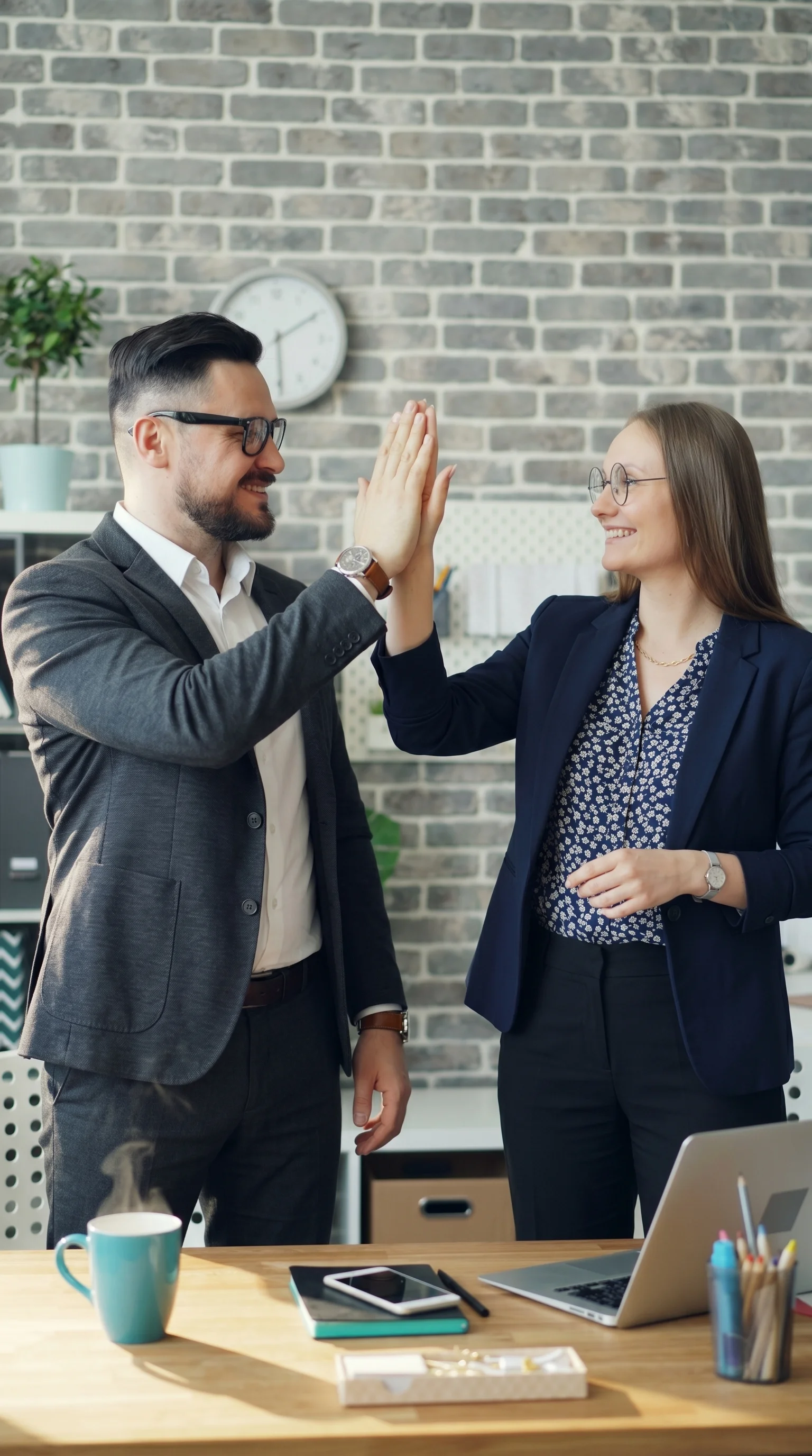 Two environmental consulting professionals celebrating a successful project outcome, representing RidgeLine Canada's positive experience with Matidor
